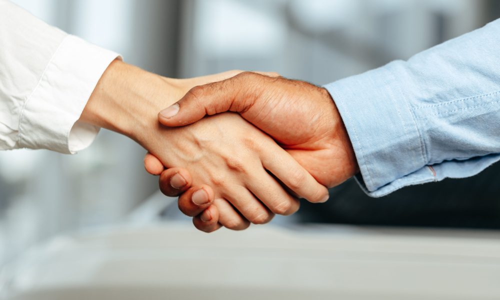 Female and male businesspeople handshake close up photo