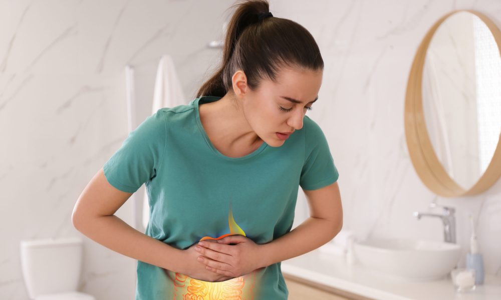 Healthcare service and treatment. Woman suffering from abdominal pain in bathroom. Illustration of gastrointestinal tract