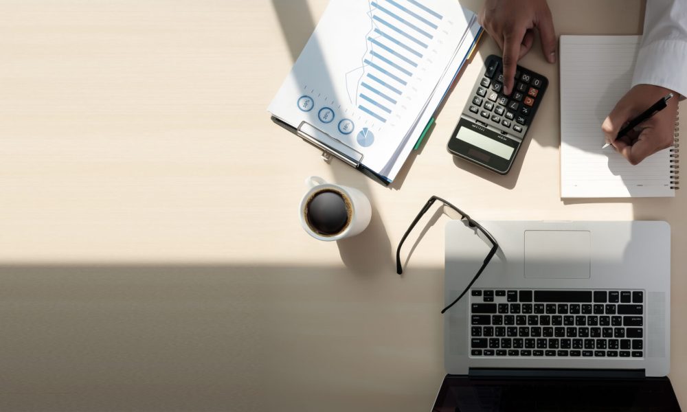 Close up businessman using calculator on documents Unrecognizable finance  use calculate about cost at office